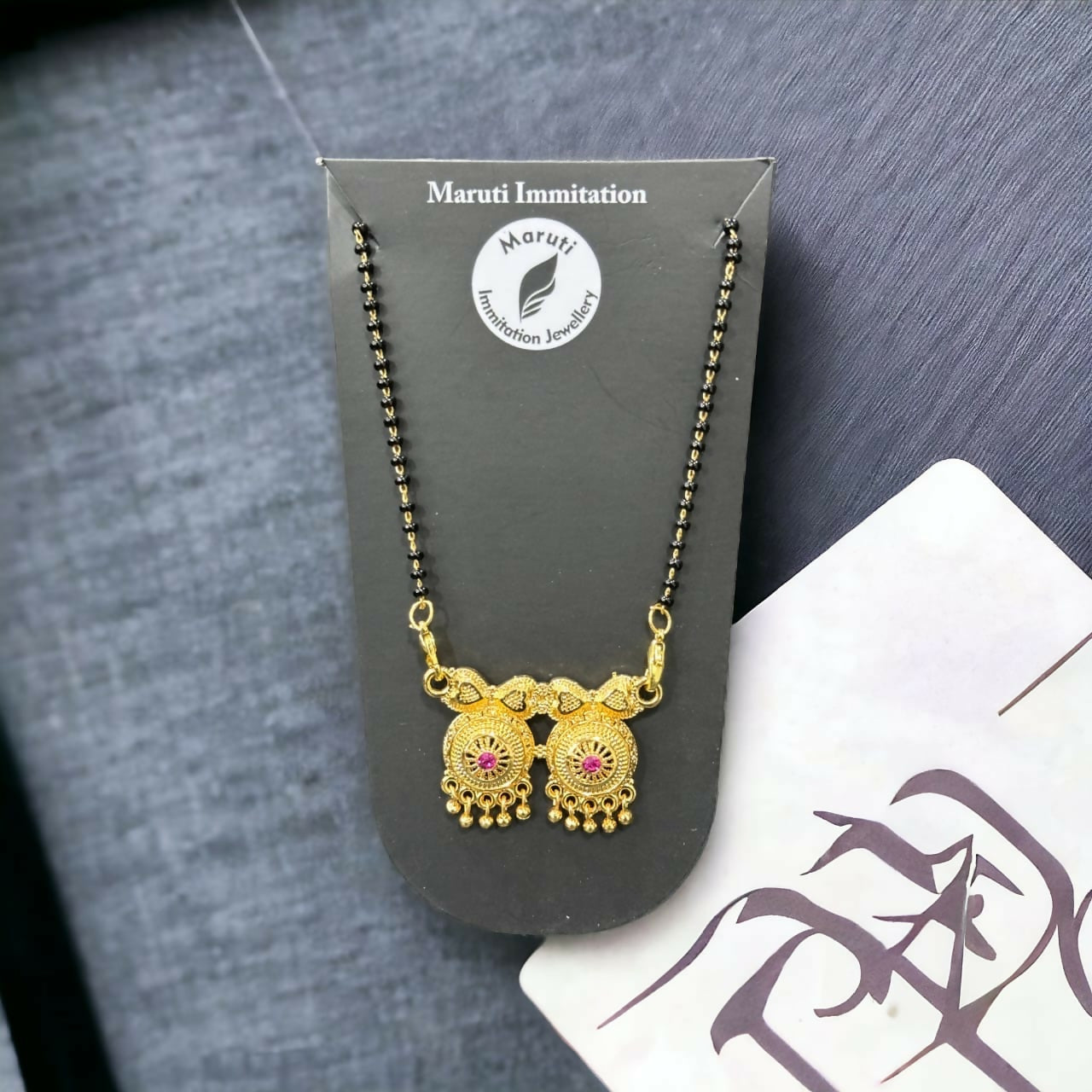 Elegant Artificial Gold-Tone Mangalsutra with Dual Pendant & Pink Stone Detailing